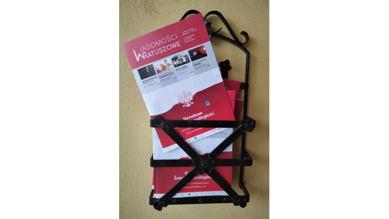 Kilkanaście egzemplarzy nowego numeru Wiadomości Ratuszowych włożone do koszyka na gazety, który znajduje się przy drzwiach wejściowych Urzędu Miejskiego w Cieszynie